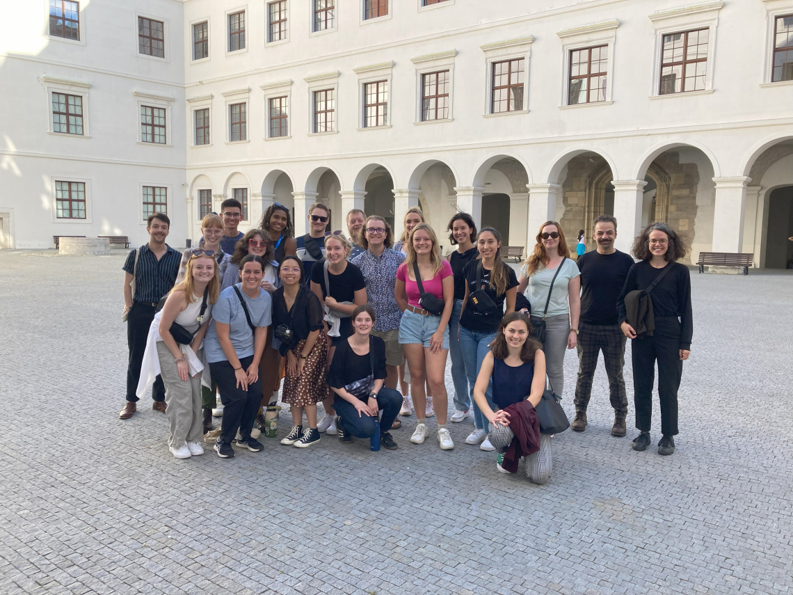 Group of people standing in a large courtyard